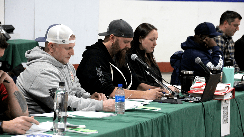 Members of the MWF Local 1 bargaining committee seated at a table during a ratification meeting.