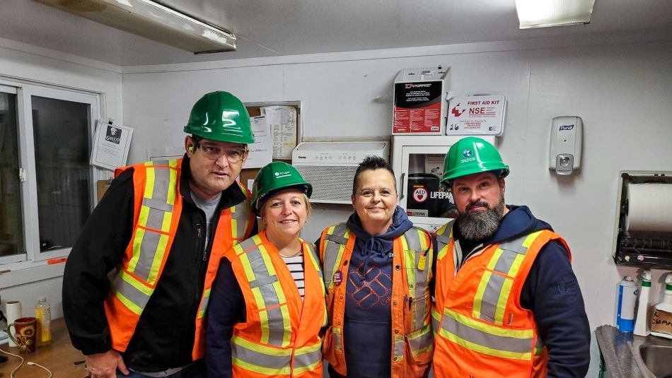 Unifor Atlantic Regional Director Jennifer Murray and three other people in high-vis vest and hard hats.