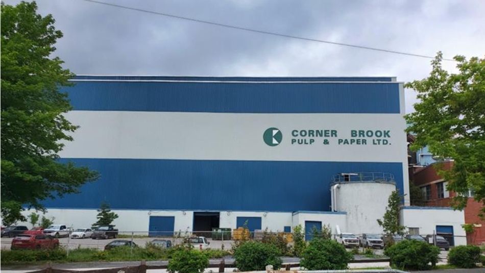 The exterior of a large industrial building with the Kreuger Paper logo on it.