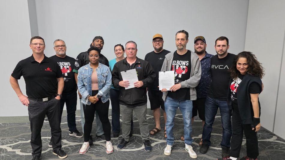 A group of people wearing Elbows up t-shirts.