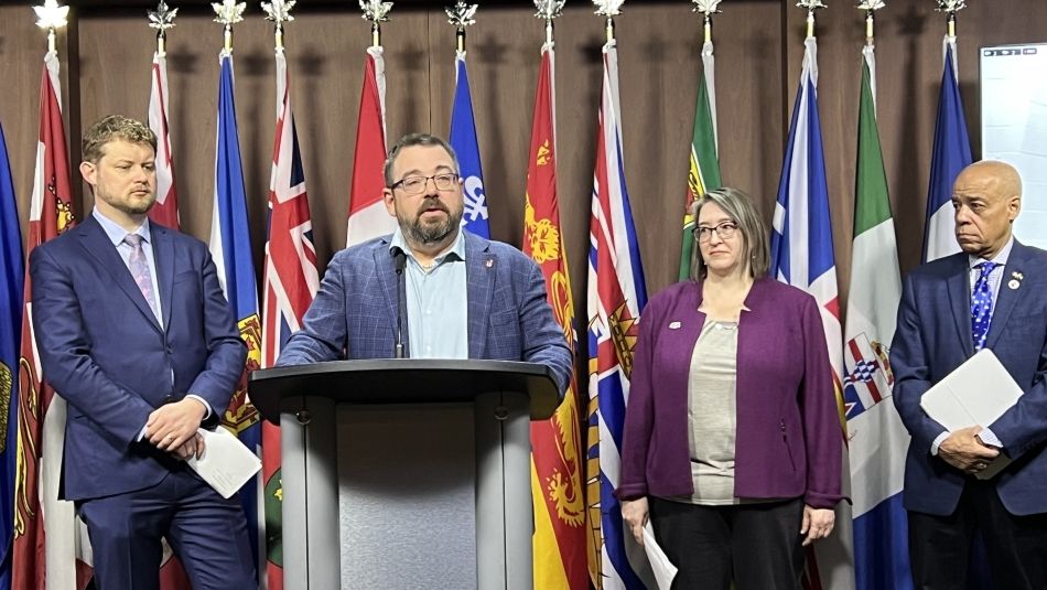 Unifor Quebec Director Daniel Cloutier standing at a podium.