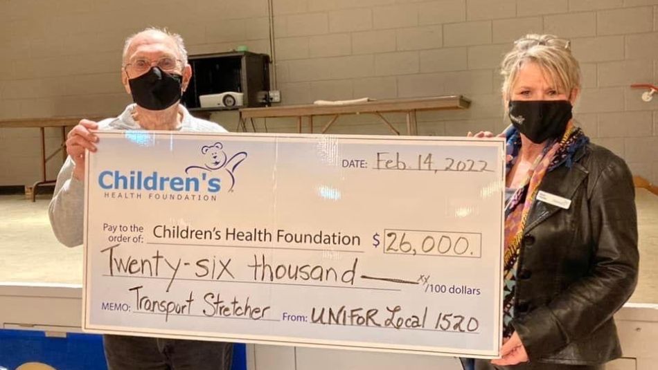 Retired Workers Chapter Local 1520 Chair Bob Such presents a giant cheque to Vicki Hayter, Director of Legacy Giving at Children's Hospital London.