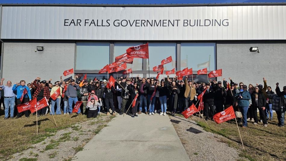 People gathered with flag in front of the municipal government building in Ear Falls