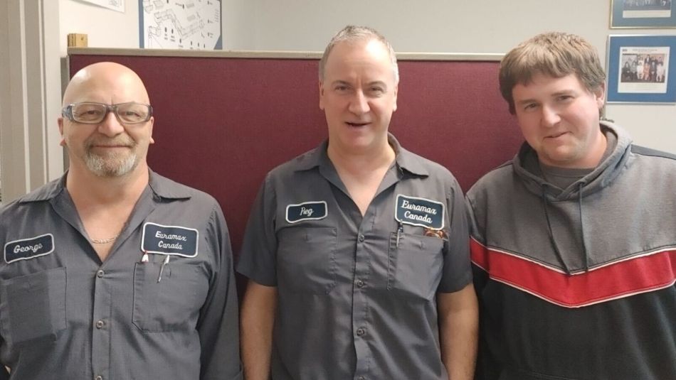 Three men posing for a photo.