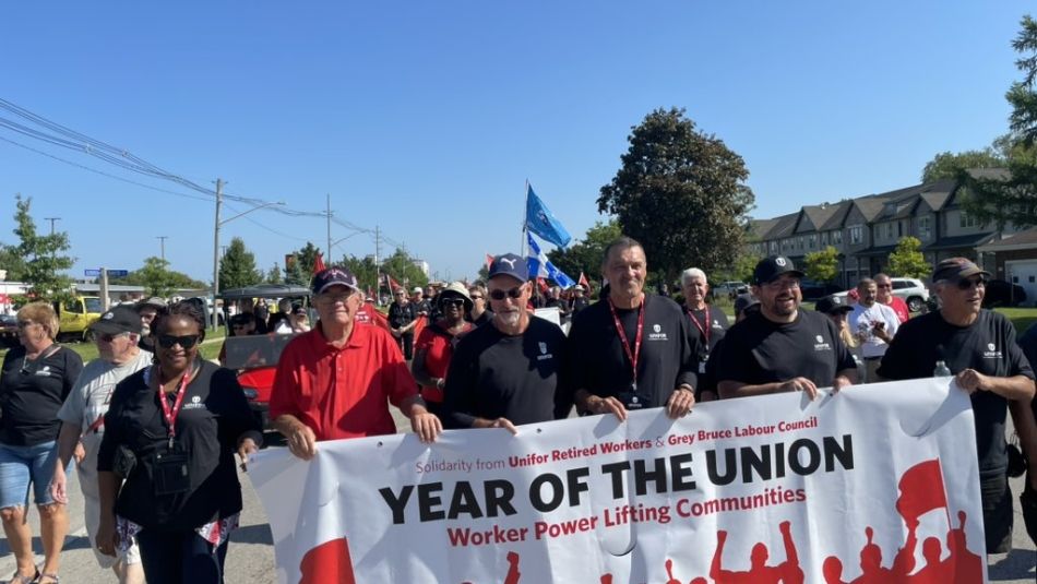 A group of people carrying a banner.