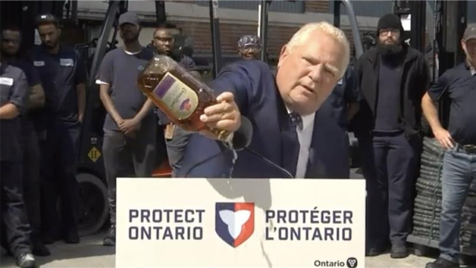 Premier Doug Ford pour out a bottle of Crown Royal