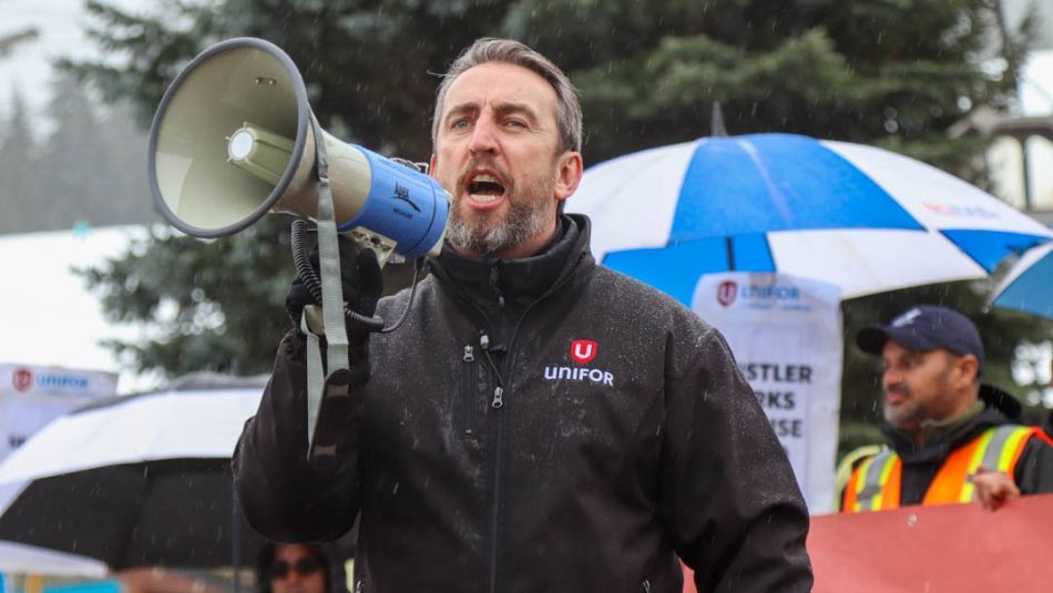 Gavin McGarrigle speaking into a megaphone outdoors