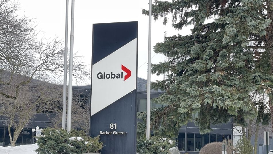 Global News signage with trees and snow in the background.