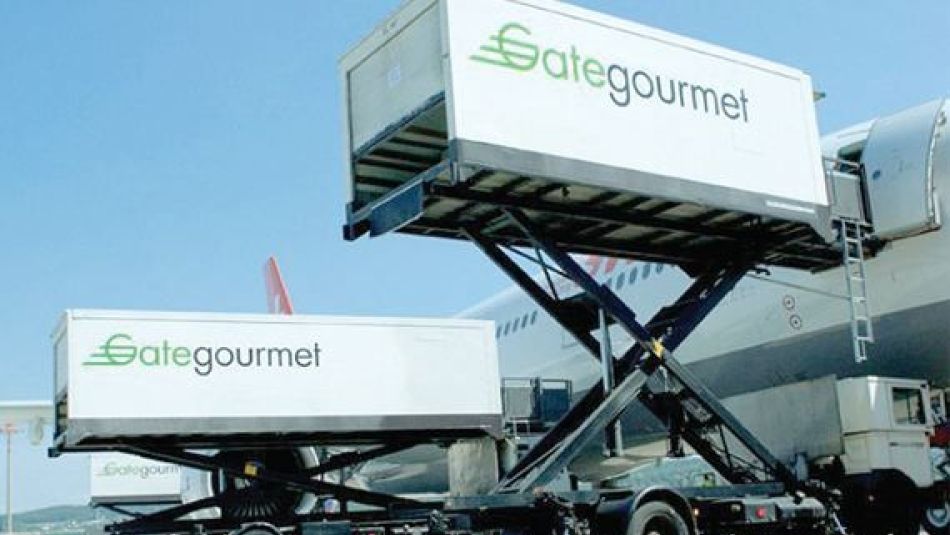 Two shipping containers hoisted above the ground with an airplane in the background.