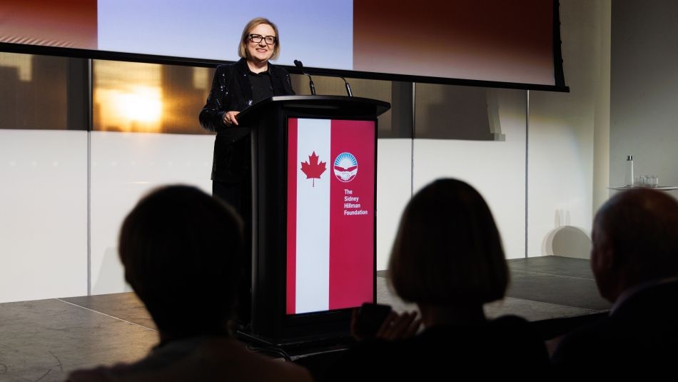 A women speaking at a podium