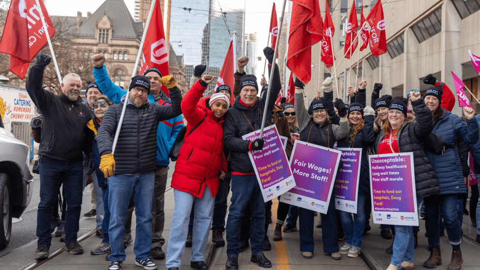 A rally group holding place cards and flags