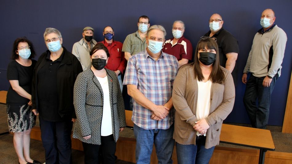 Members of the Support Unit Bargaining Committee stand together following May 18 negotiations