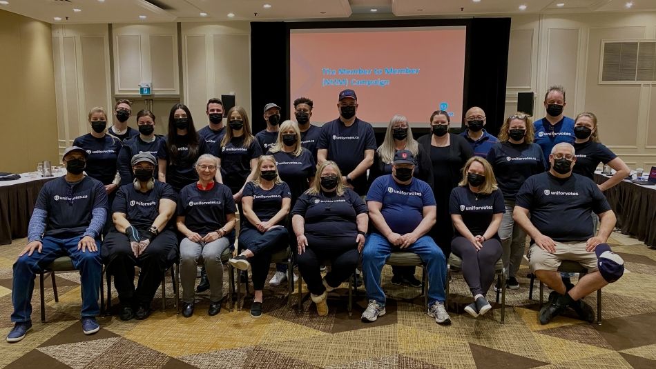 Unifor members pose with Unifor Votes t-shirts