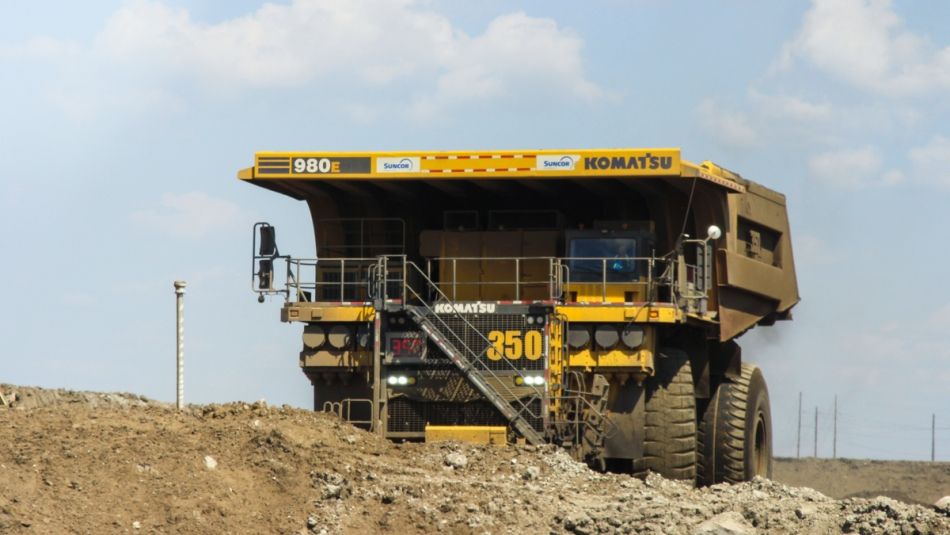 Very large yellow heavy-hauler dump truck