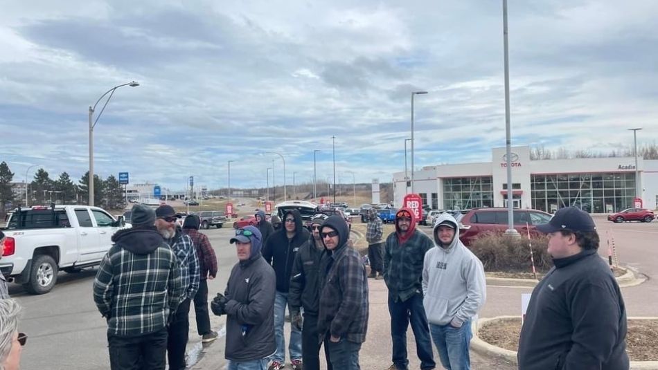 Workers picket outside Moncton Toyota