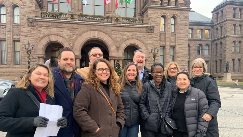 People gathered outside Queen's Park in the cold.