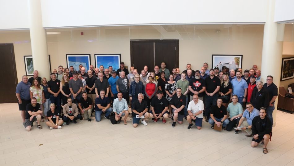 A large group posing in a lobby