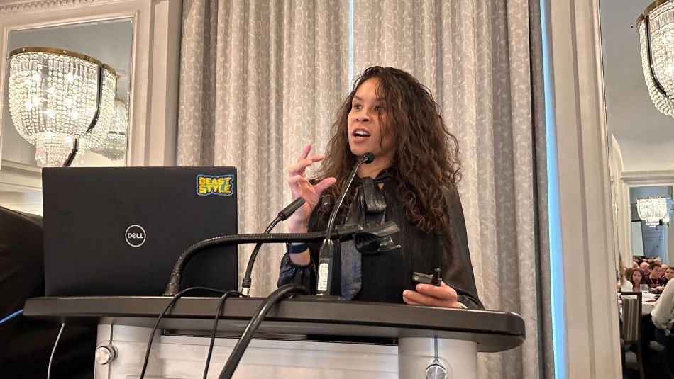 A woman speaks at a podium.