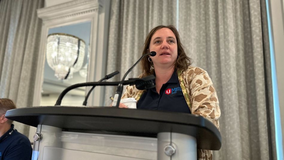 A woman speaks at a podium