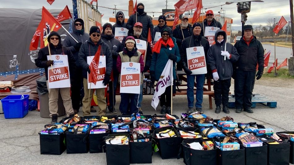 A group of people standing outside bins of items