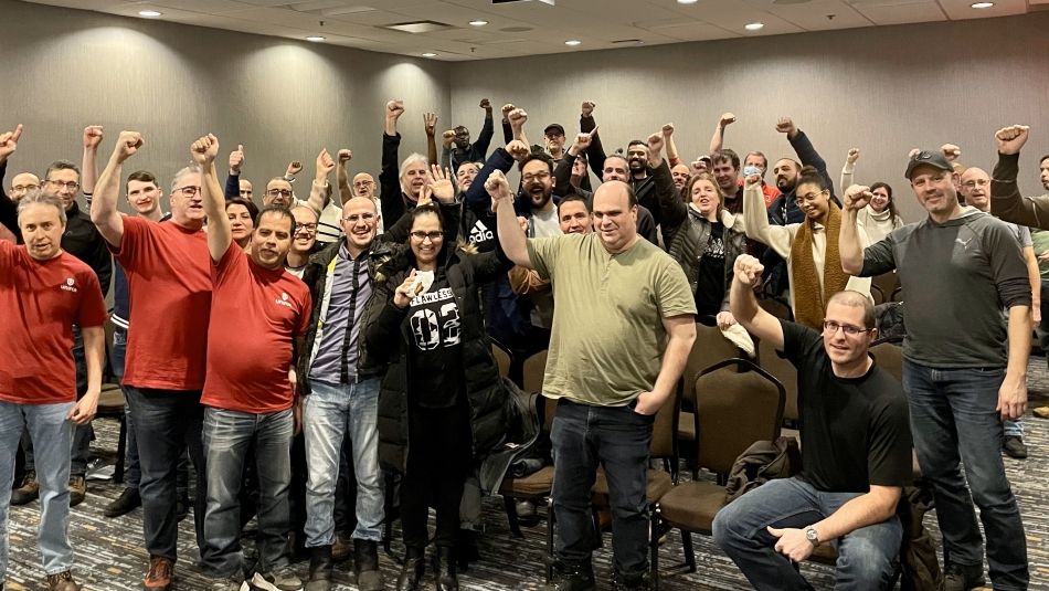 A group of people, some with raised fists in the air.