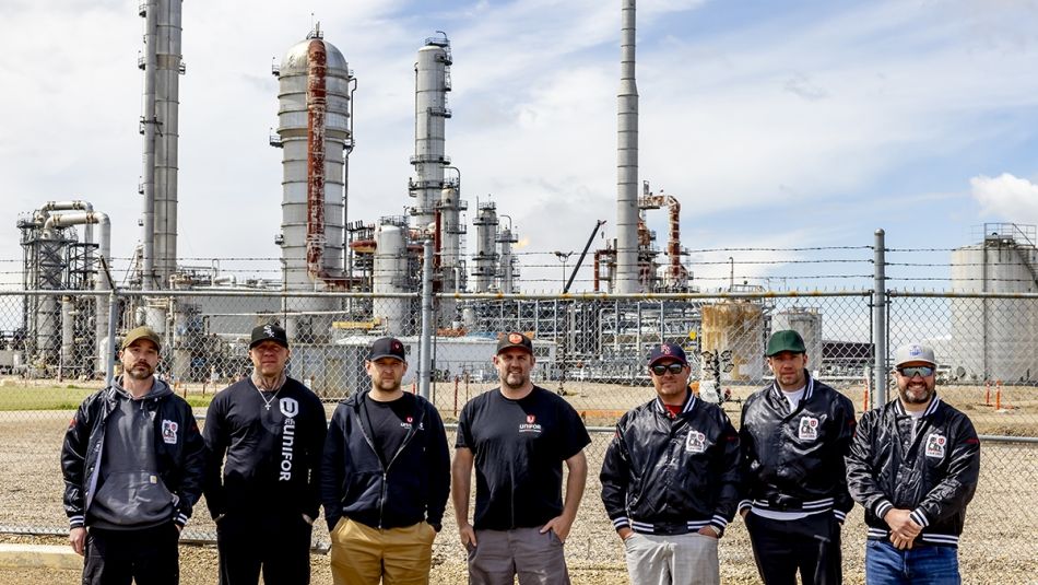 Unifor Local 530-A bargaining committee. Seven people standing outside with a refinery behind them.