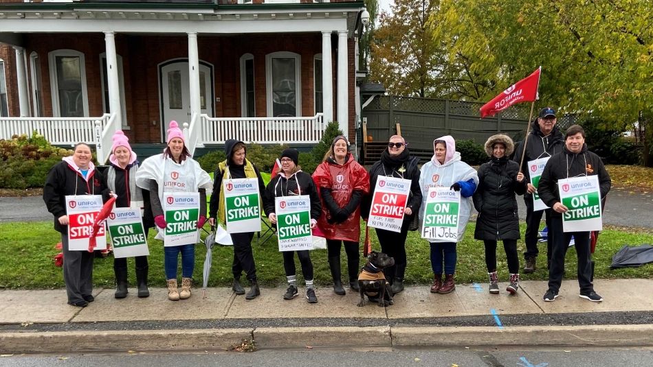 women on the picket line holding signs 