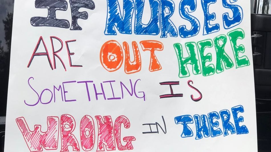 Handmade rally sign that reads "If nurses are out here, something is wrong in there"