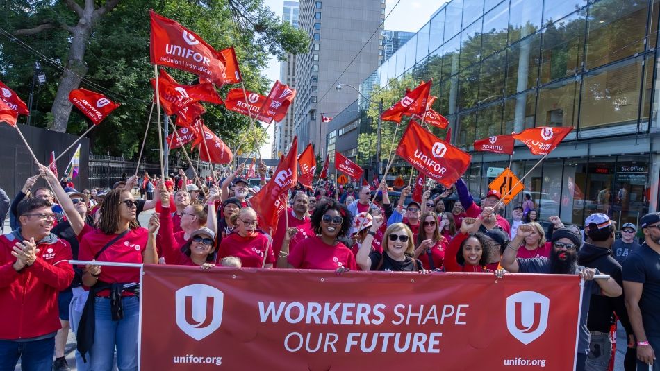 Toronto Labour Day Parade A large group of Unifor members marching behind a banner