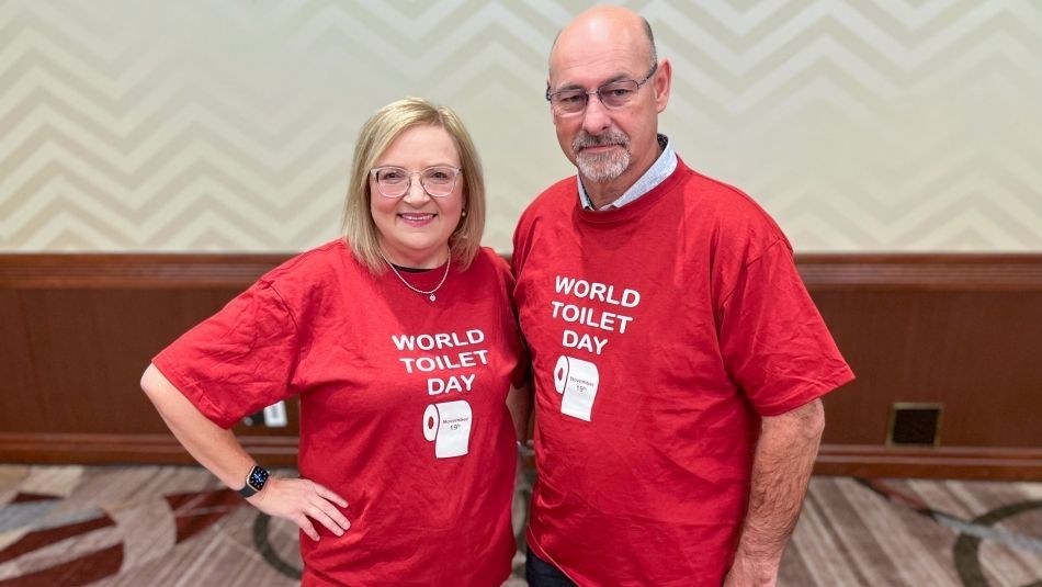 two people wearing red World Toilet day t-shirts