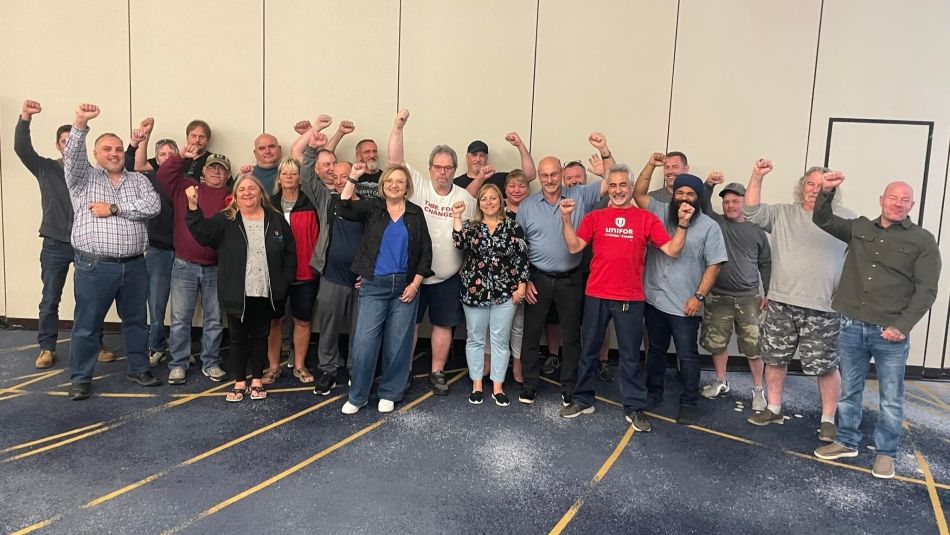 Loomis bargaining committee in group shot with fists in the air