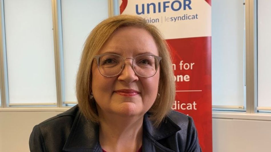 Lana Payne in front of a Unifor pop up banner.