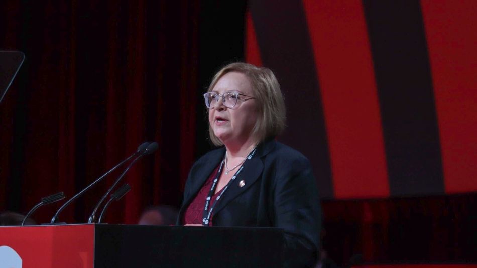 Lana Payne stands at the Convention podium speaking to delegates