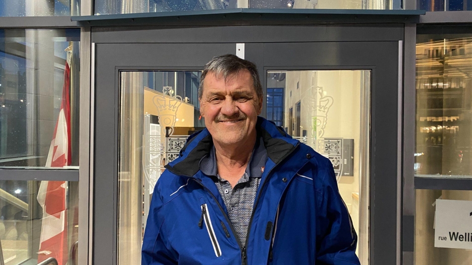 Les MacDonald smiles outside a Senate Meeting