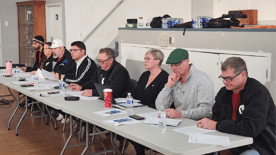 Group photo of Unifor Local 1285 bargaining committee members seated together indoors at the F&P manufacturing ratification meeting.
