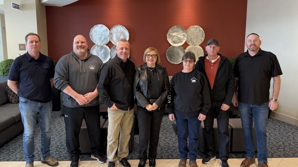 Unifor National President Lana Payne standing with members of the General Dynamics Land Systems bargaining committee.