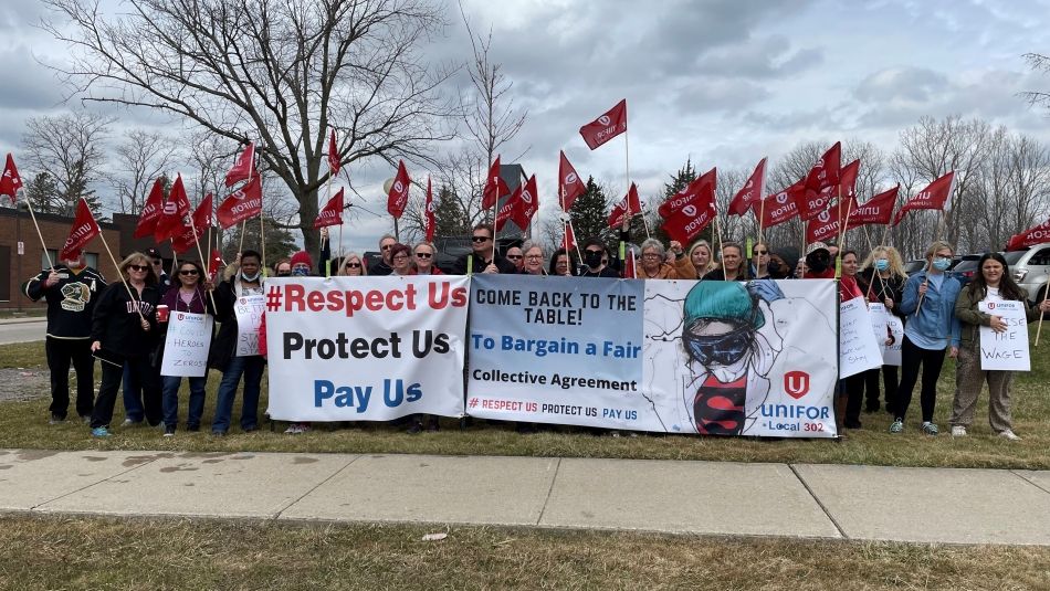 Unifor health care workers hold signs at a London LTC rally. 