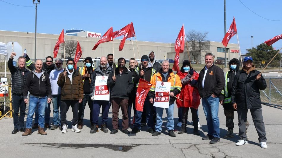 members on the picket line holding flags and signs