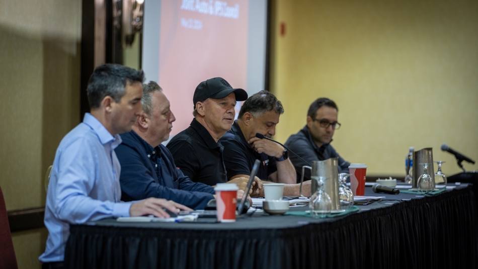 Unifor Auto IPS joint Council Men sitting at a table with microphones in front of them