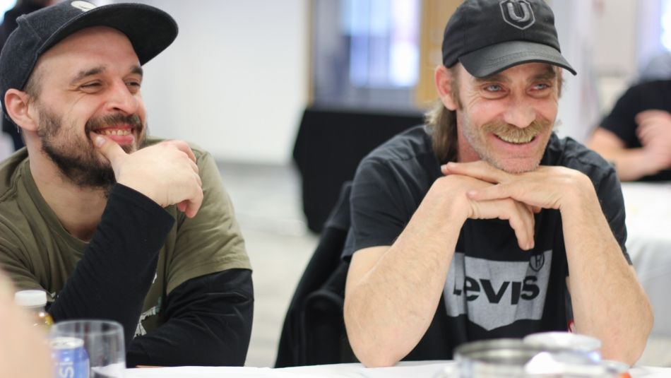 Two men listing at a BWP meeting in Moncton