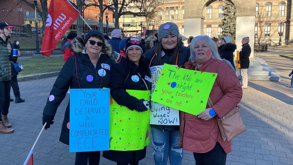 Unifor members working as early childhood educators standing with their Unifor National representative, Susan Gill, as a rally in Halifax.