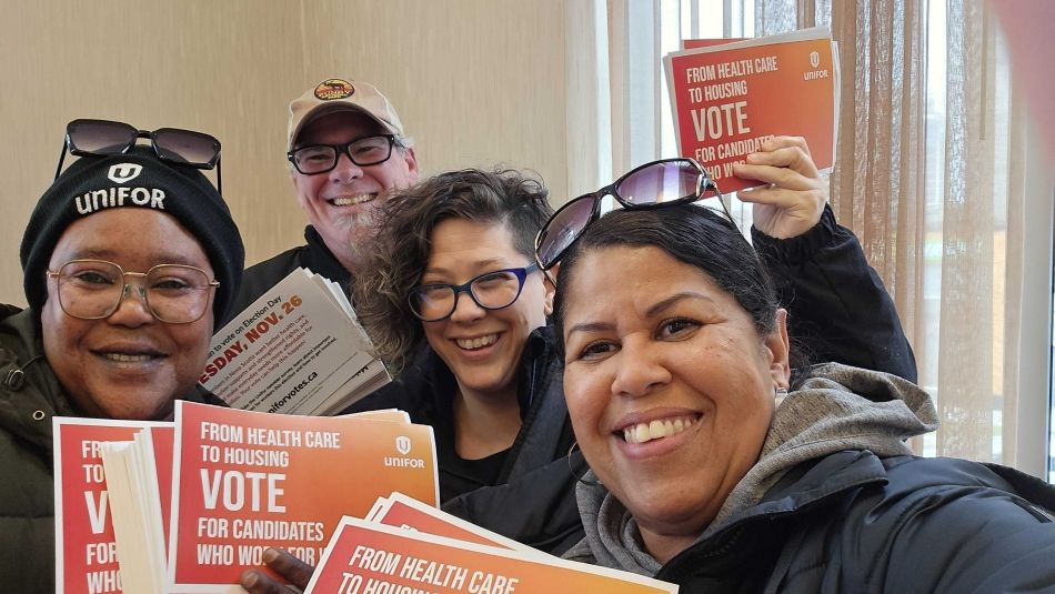 Four people canvassing with postcards