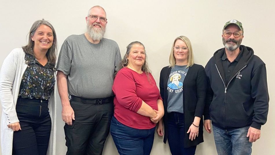 Five people against a wall.