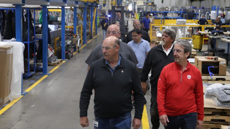 A group of people walking through a warehouse