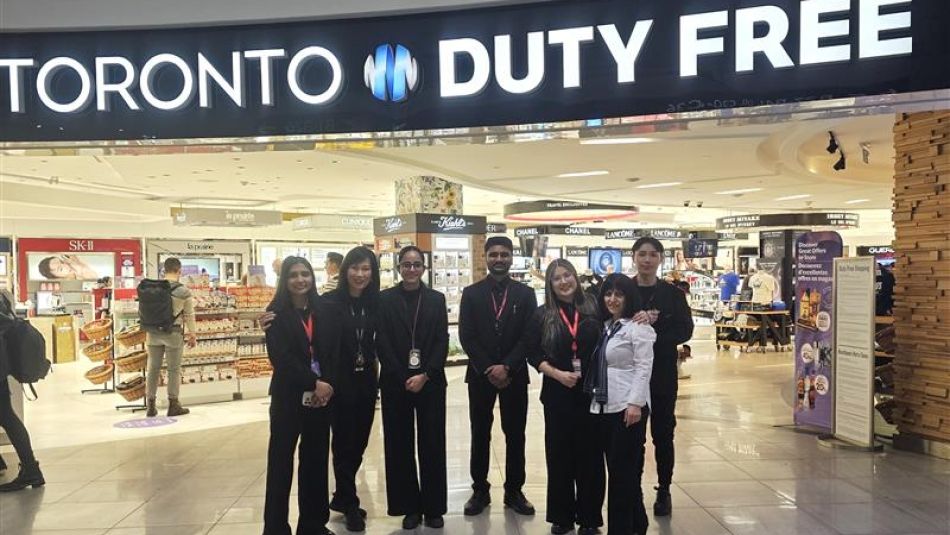 Seven people in uniform stading outside of a Toronto Duty Free shop.