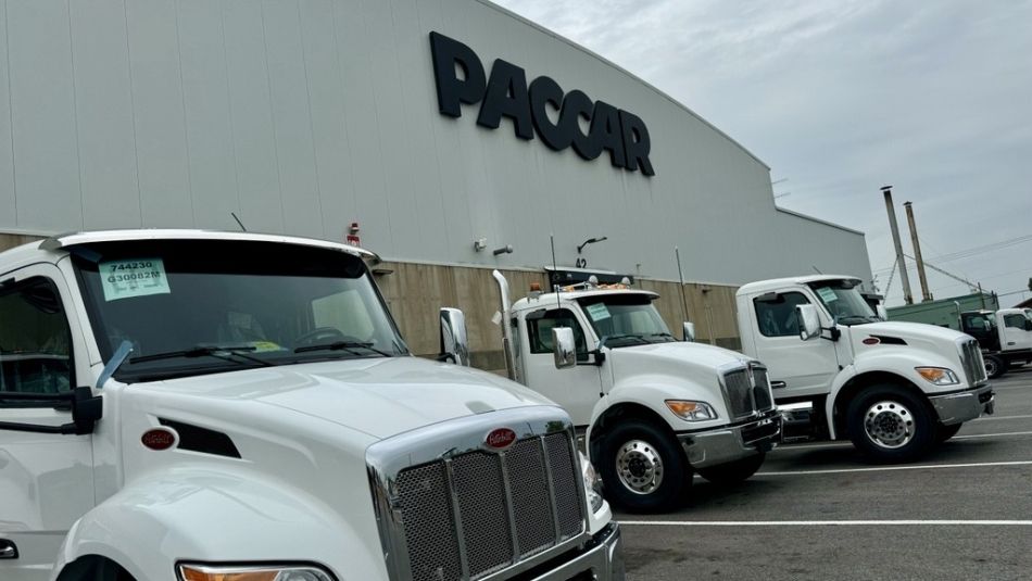 Exterior PACCAR building with trucks parked outside