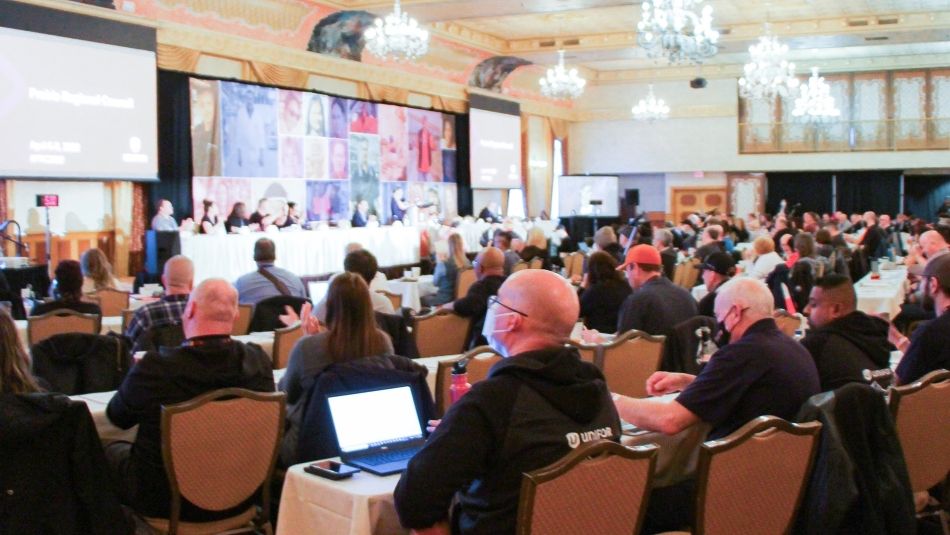 Full ballroom of tables with delegates