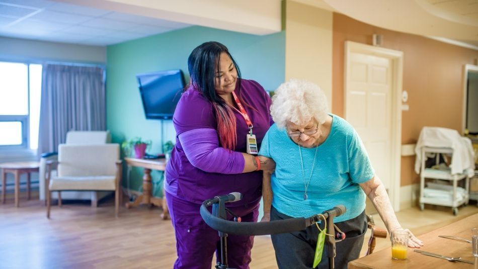 A personal support worker assisting a old women