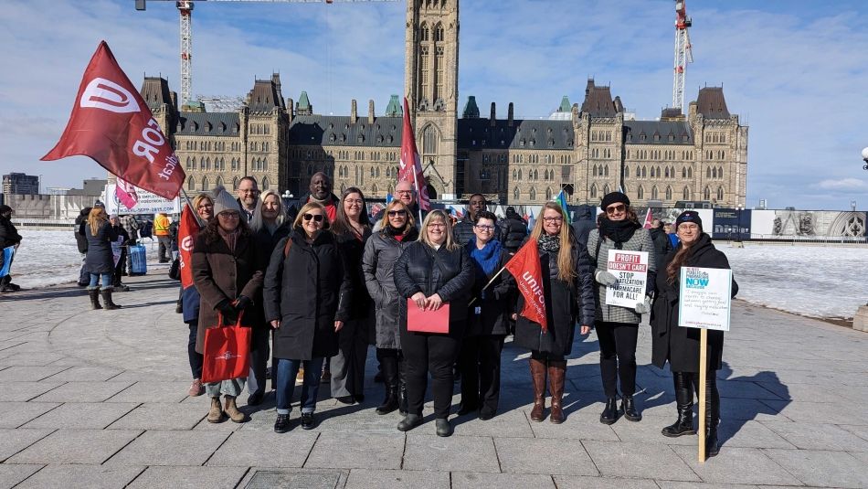 Unifor President Lana Payne stands with health care activists in front of Parliament Hill in Ottawa.