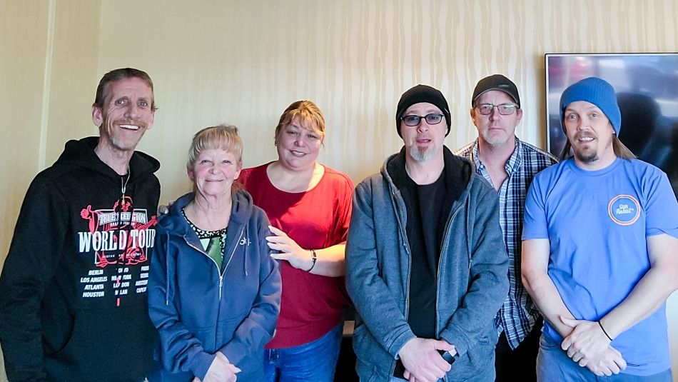 "Six members of the Local 1410 bargaining committee standing and posing indoors for a photo."